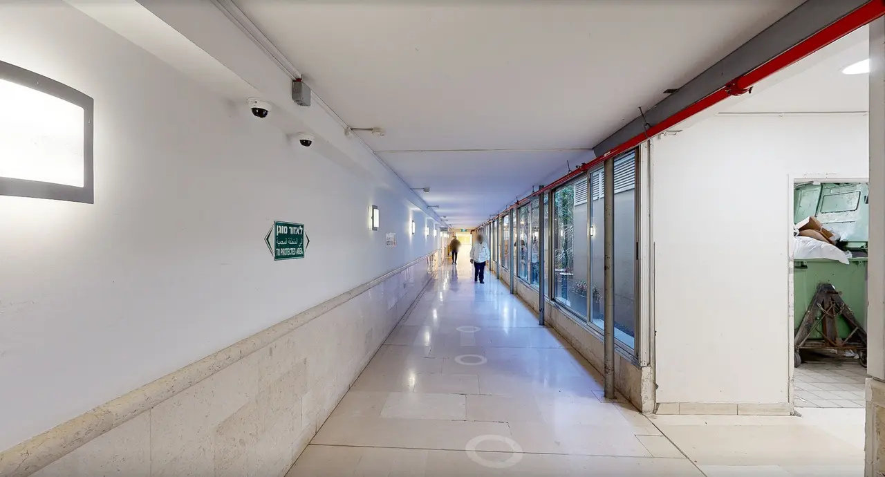 A long Beilinson corridor with a sign to the protected area